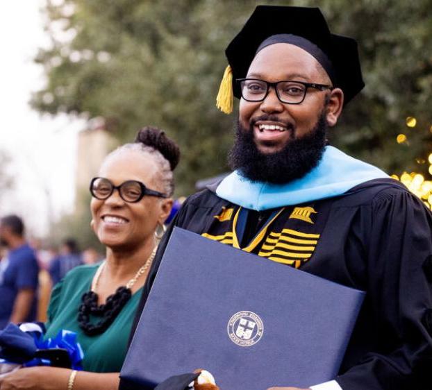 A graduate school student celebrates earning his degree